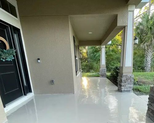 Residential epoxy flooring on a screened patio porch