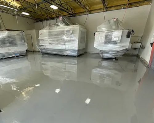 Workshop floor before / after solid gray epoxy coating