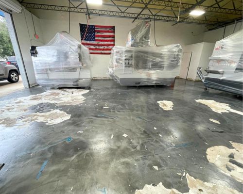 Workshop floor before / after solid gray epoxy coating