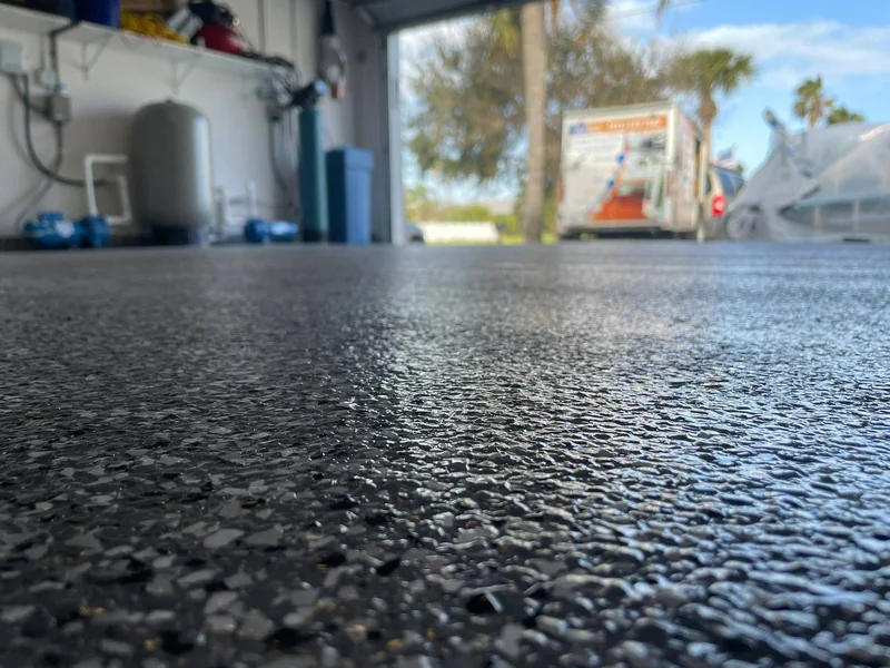 Dark flake epoxy garage floor, close-up detail